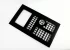 A black plastic control panel faceplate with multiple cutouts for buttons, switches, and a display screen.